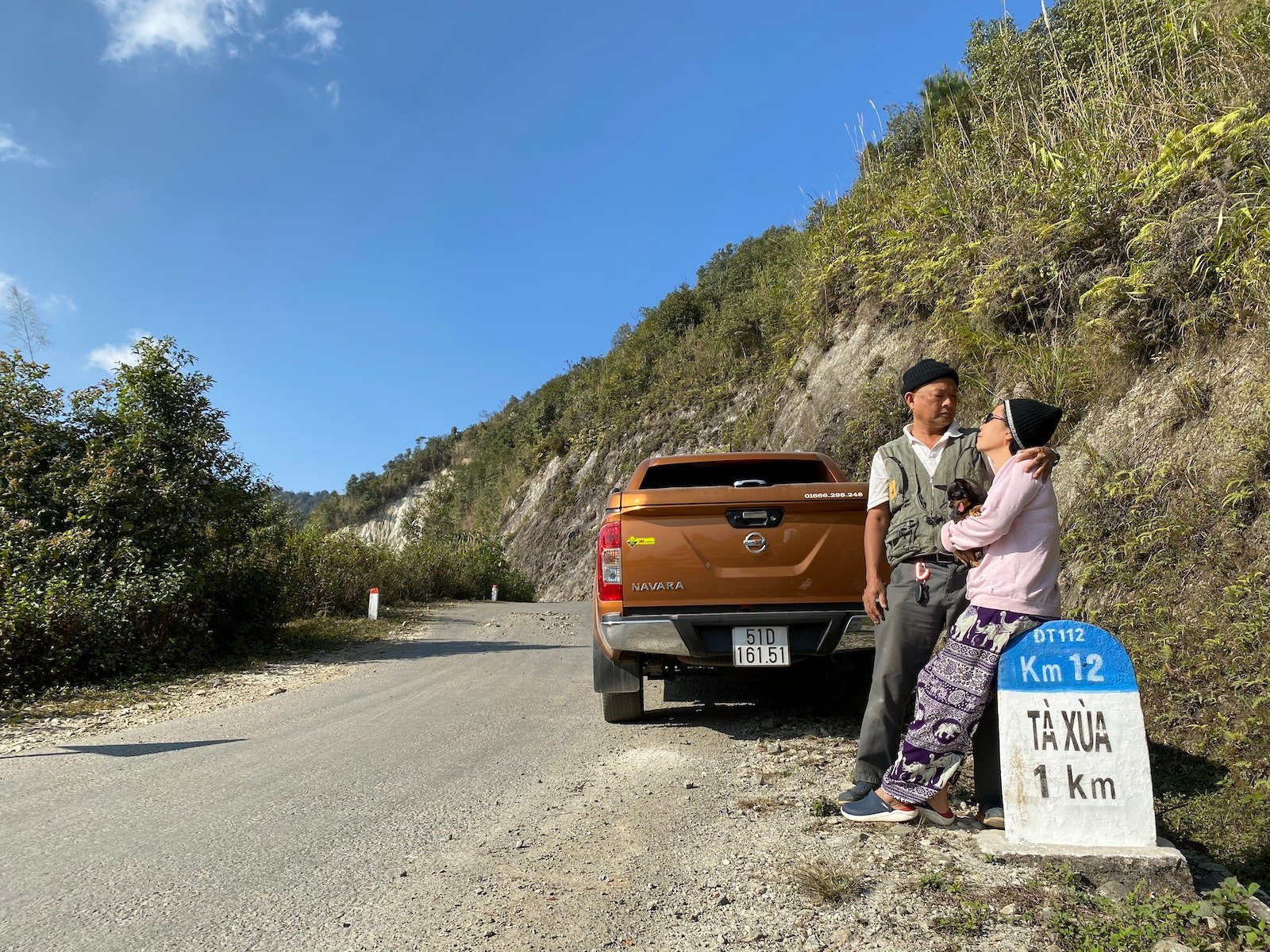 Old Asian couple traveling together on truck